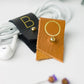 Black and warm golden leather cord organizers with customized B and O letters, individually crafted by Keyaiira for headphones, phone chargers, device cords and portable tech storage
