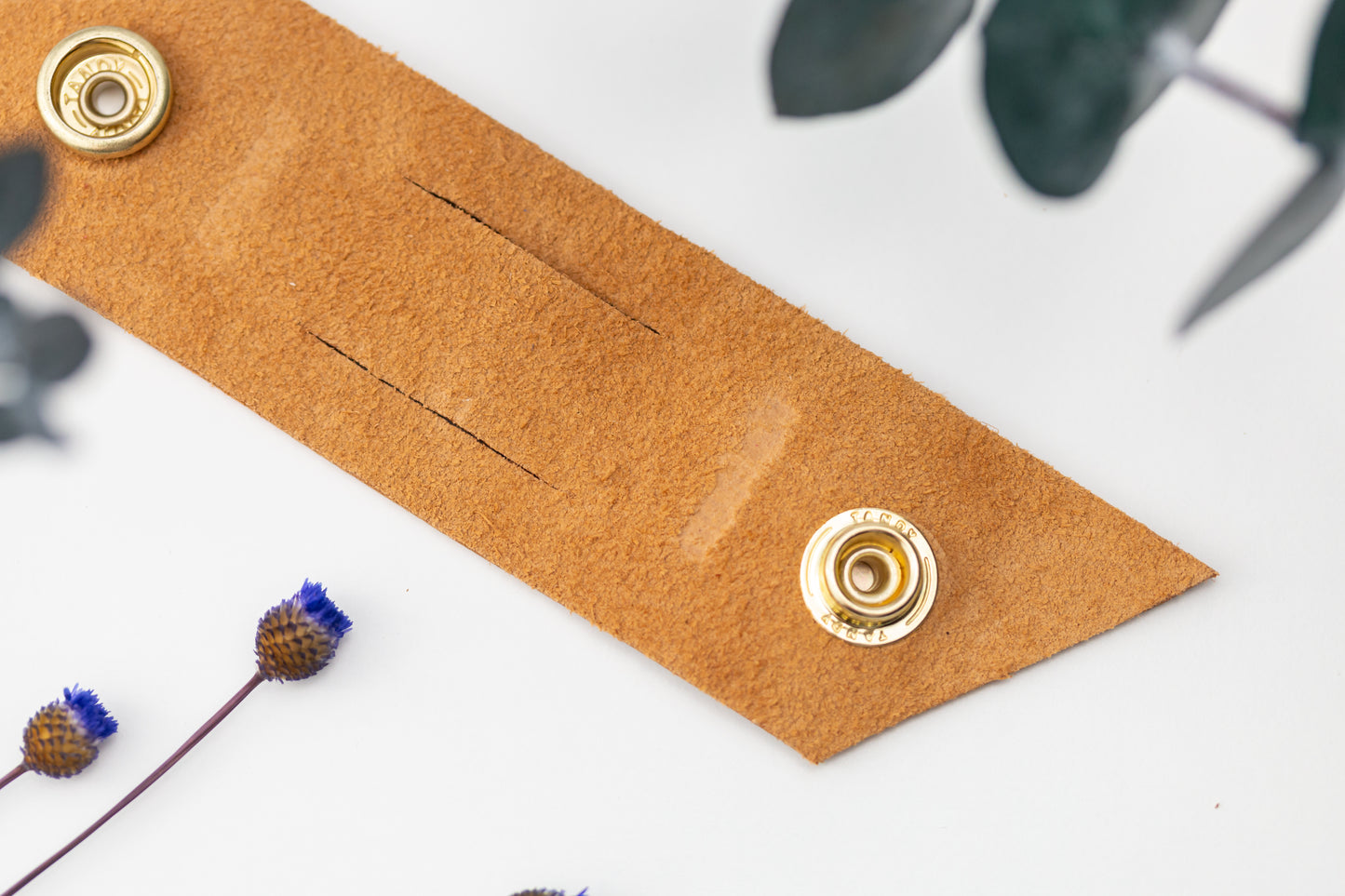 Genuine Cognac leather cable management strap with brass snap hardware, handcrafted by Keyaiira for bulky charger cords, power cables, computer wires and home office organization
