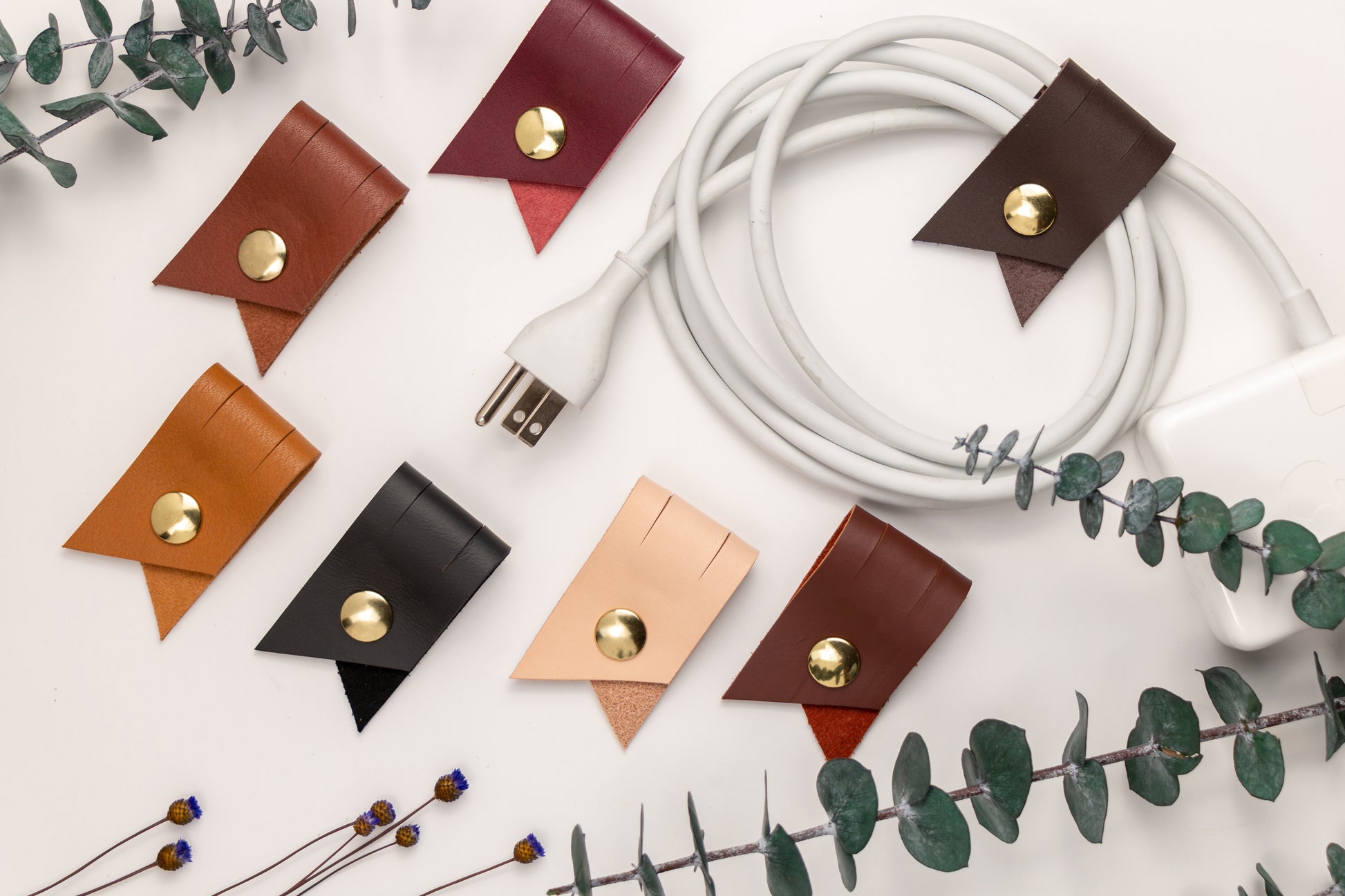 Handcrafted leather cable keeper collection in assorted colors, reusable Keyaiira cord wraps for device chargers, computer cables, power cords and clutter-free workspace storage
