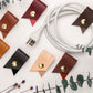 Custom monogram leather cord holders with personalized initials in assorted colors, handmade cable organizers and charger wraps for tech storage, travel accessories and personalized gifts by Keyaiira
