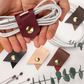 Personalized leather cord organizer video demonstrating a custom monogram cable holder, reusable handmade charger wrap for charging cords, USB cables and portable tech organization by Keyaiira
