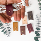 Custom-lettered Wine leather cord holder displayed with assorted Keyaiira color choices, artisan-made for earbud storage, charging cables, USB cords and organized tech essentials
