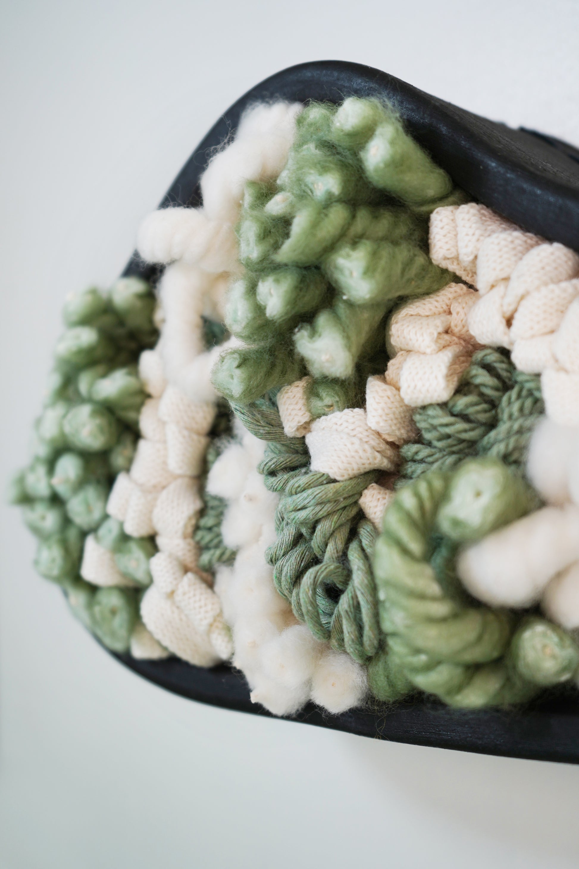 Detailed close-up of woven fiber filling, focusing on the intricate weave of braided 100% Egyptian cotton and chunky cotton string. Showcases the high-quality craftsmanship and mix of textile techniques used within the ceramic frame.