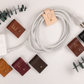 Handmade genuine leather cable organizers in assorted Keyaiira colors, reusable large cord wraps for phone chargers, USB cables, power cords and clutter-free electronics storage
