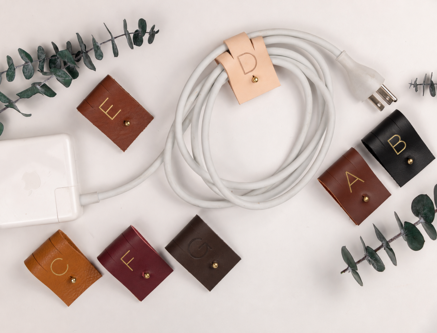 Handmade genuine leather cable organizers in assorted Keyaiira colors, reusable large cord wraps for phone chargers, USB cables, power cords and clutter-free electronics storage
