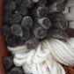 Detailed Close up of felted gray fiber showing texture and depth.