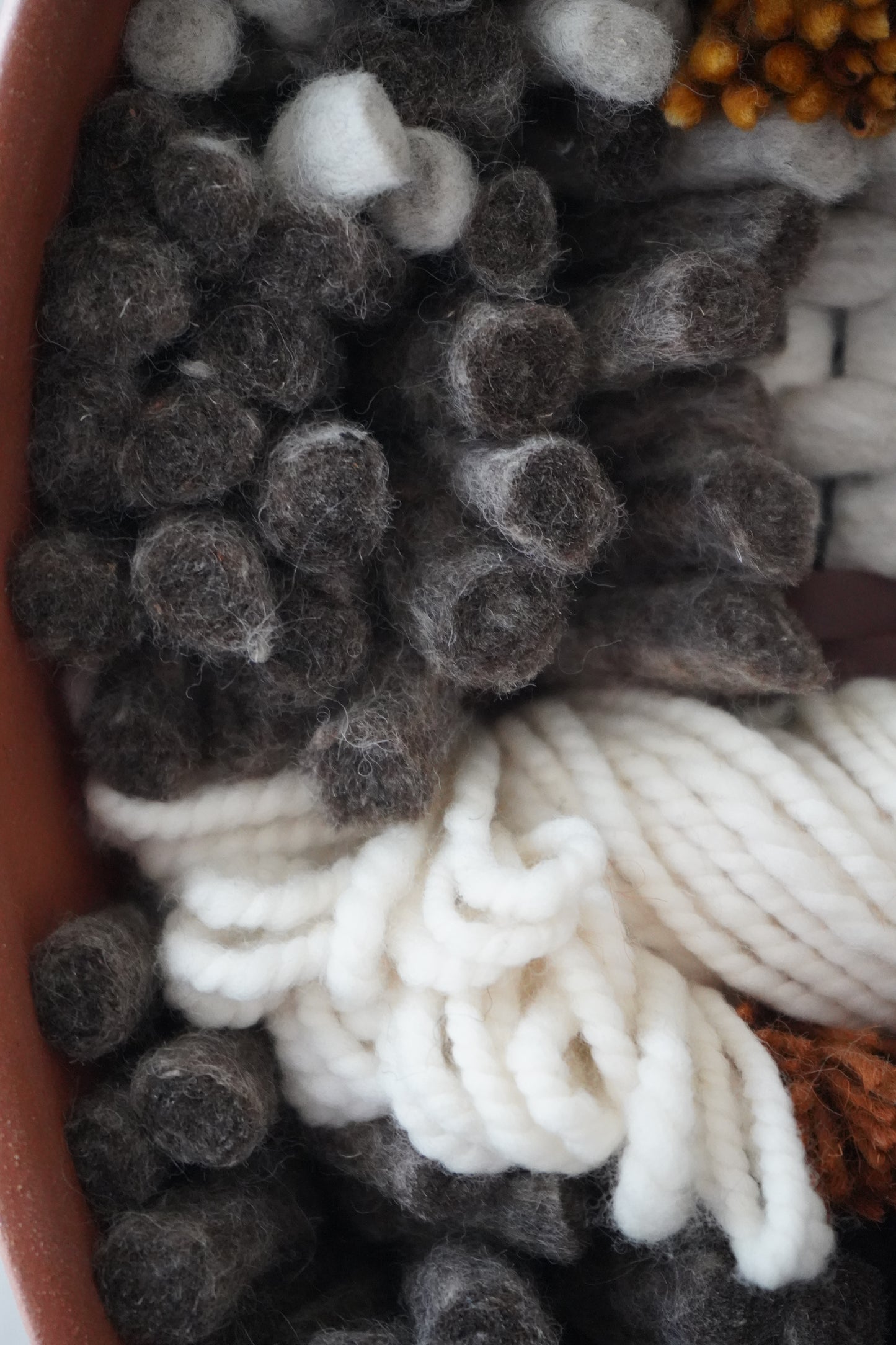 Detailed Close up of felted gray fiber showing texture and depth.