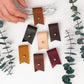Made-to-order leather cord holders with optional letter personalization, functional Keyaiira organizers for earbuds, phone cables, tech accessories and unique handmade gift ideas
