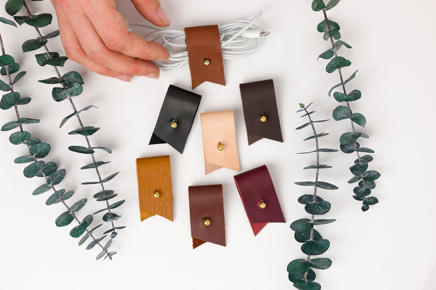 Made-to-order leather cord holders with optional letter personalization, functional Keyaiira organizers for earbuds, phone cables, tech accessories and unique handmade gift ideas
