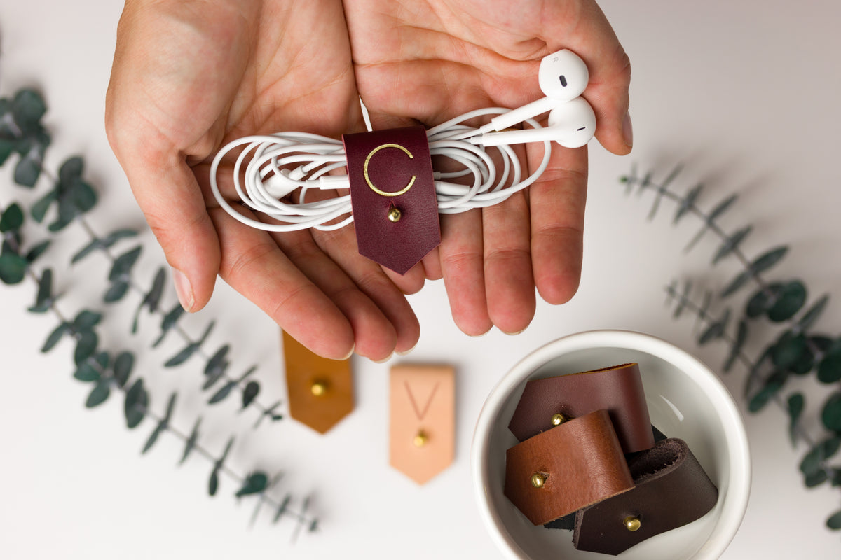 Wine full-grain leather earbud keeper with customized C initial, artisan-finished by Keyaiira for wired headphones, charging cords, small electronics and tangle-free travel storage
