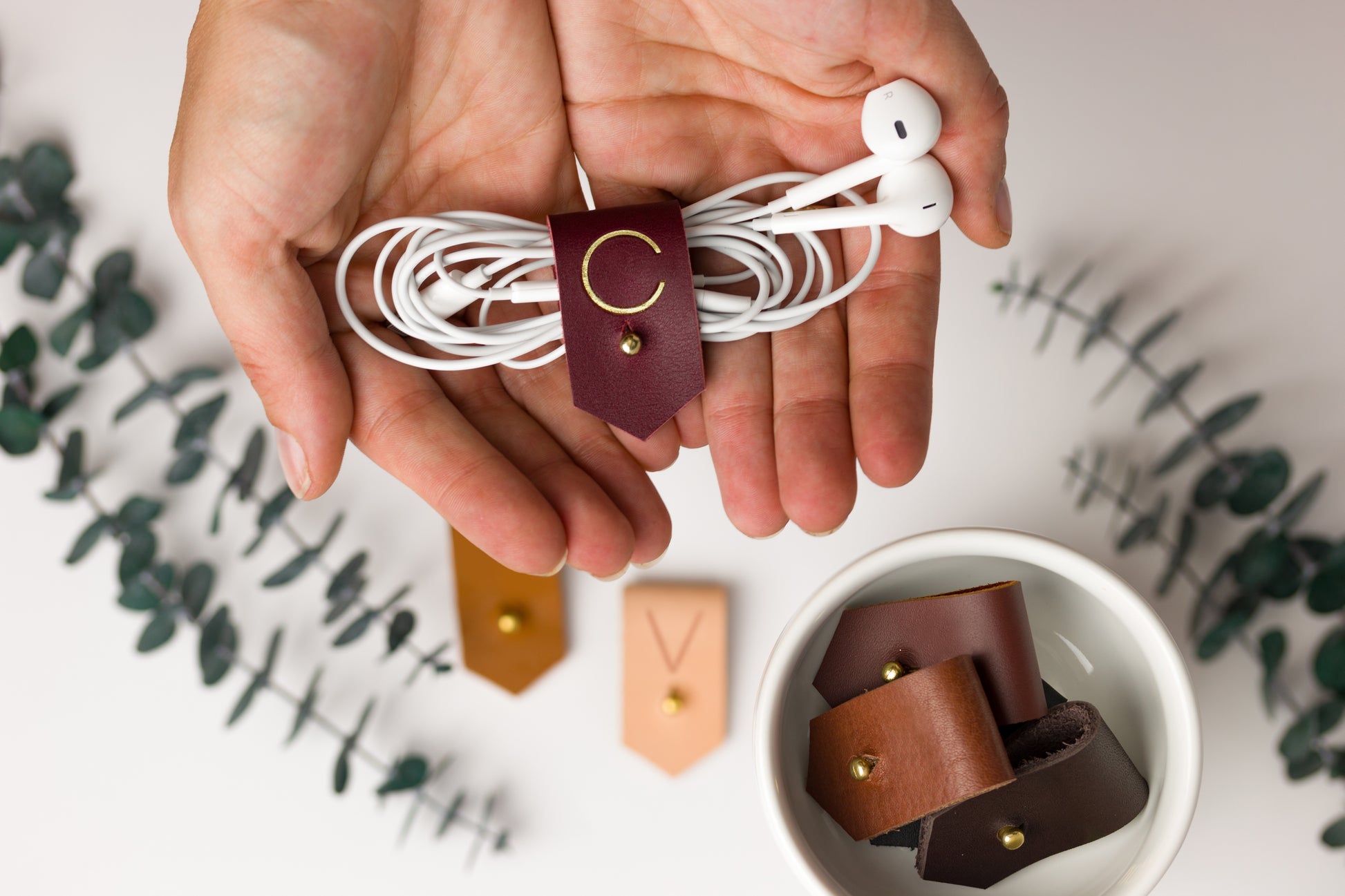Wine full-grain leather earbud keeper with customized C initial, artisan-finished by Keyaiira for wired headphones, charging cords, small electronics and tangle-free travel storage
