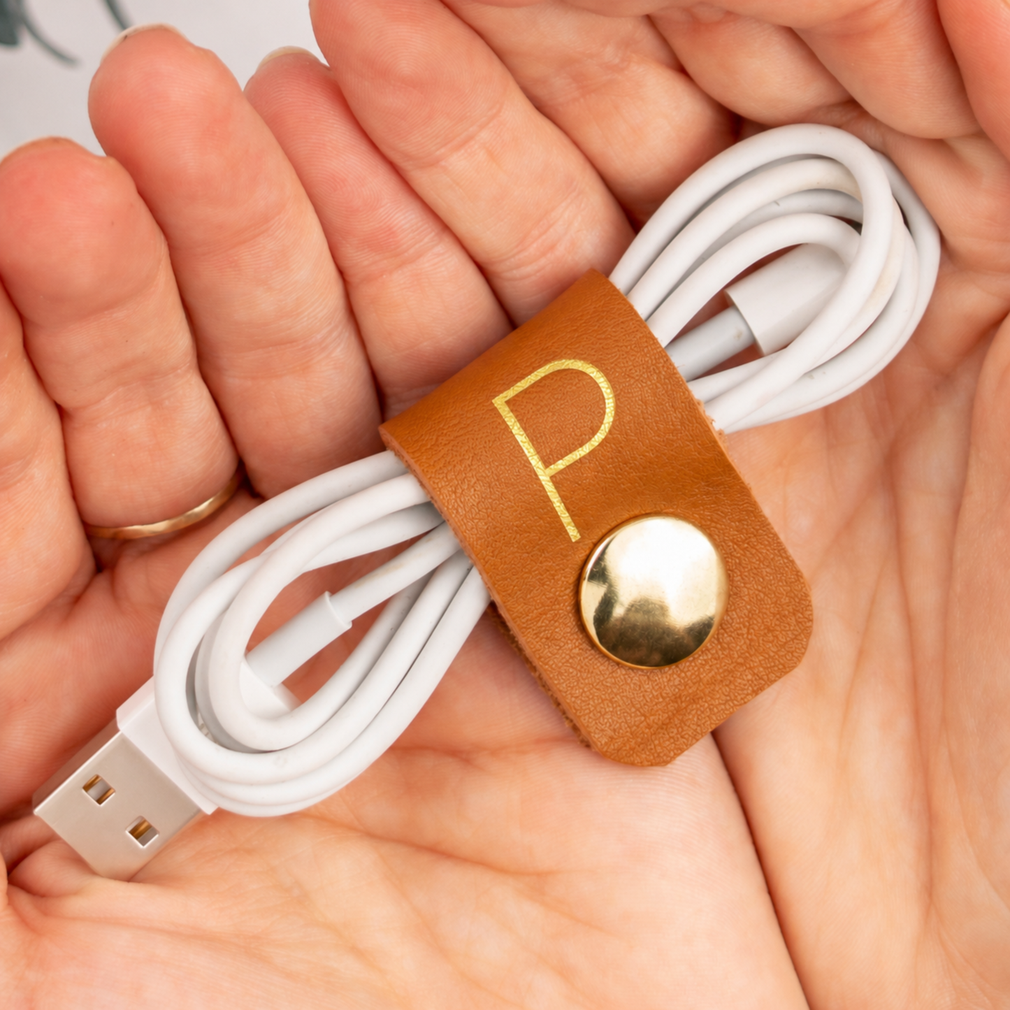Personalized leather cord organizer video showing custom initial cable holders in assorted colors, handmade cord keepers for earbuds, chargers and everyday electronics by Keyaiira
