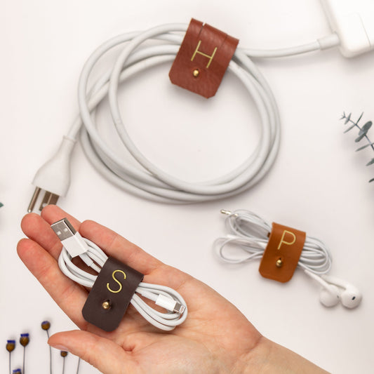 Personalized leather cord organizers for charging cables, earbuds and USB cords, custom monogram cable ties with brass hardware for desk, travel and tech organization by Keyaiira
