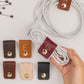 Custom Wine leather G initial cable holder shown with assorted personalized cord organizers, handmade monogram charger ties for electronics storage, desk organization and gifting by Keyaiira

