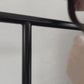 Keyaiira handmade leather art hanging strap being attached to a metal hanging rail with a brass Chicago screw for displaying framed artwork, posters, canvas prints, and wall décor.